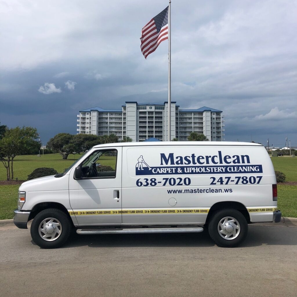 Masterclean carpet and upholstery cleaning van parked beneath an American flag